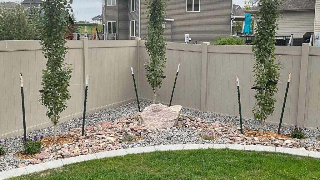 Low maintenance landscaping makes easy trim work around fencing